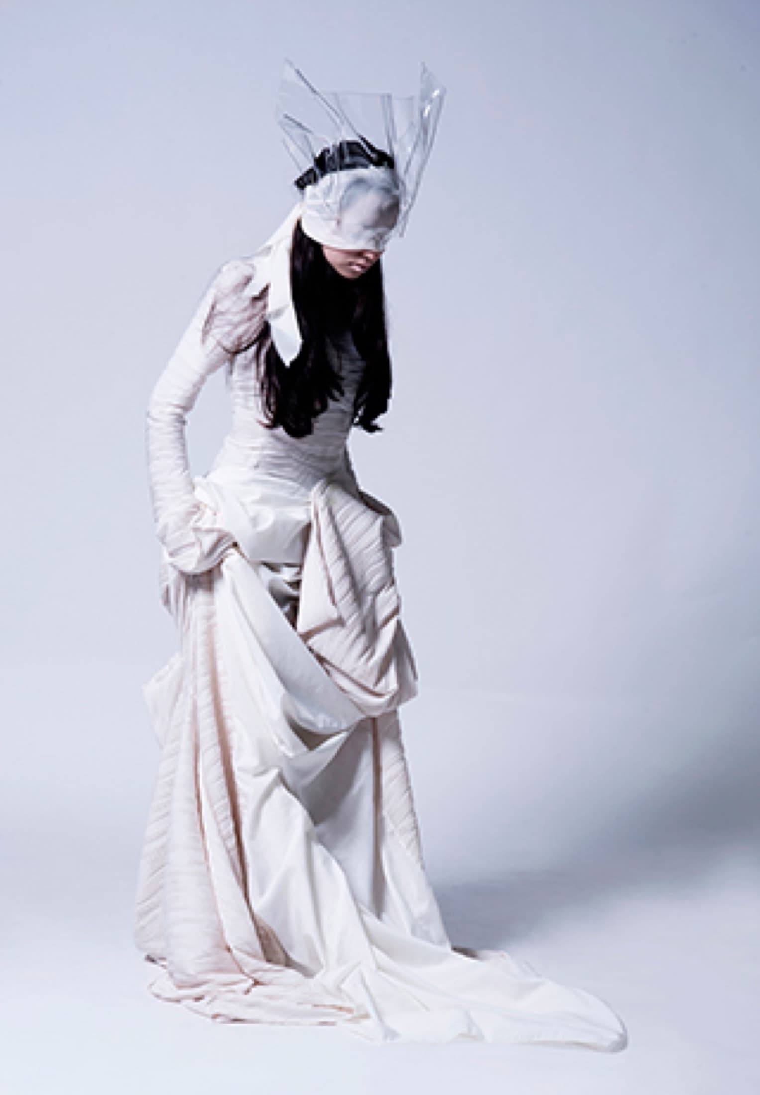 Performer dressed in white in a movement study for TIM. The Illusive Man