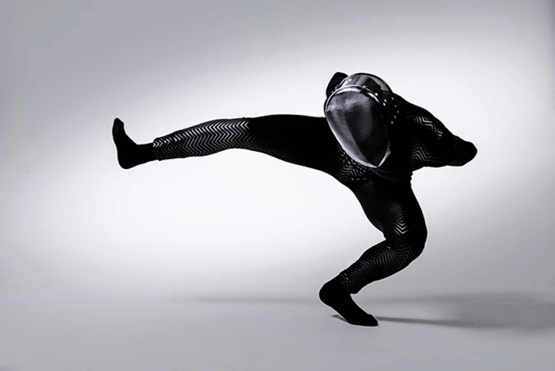 Performer dressed in black in a movement study for TIM. The Illusive Man