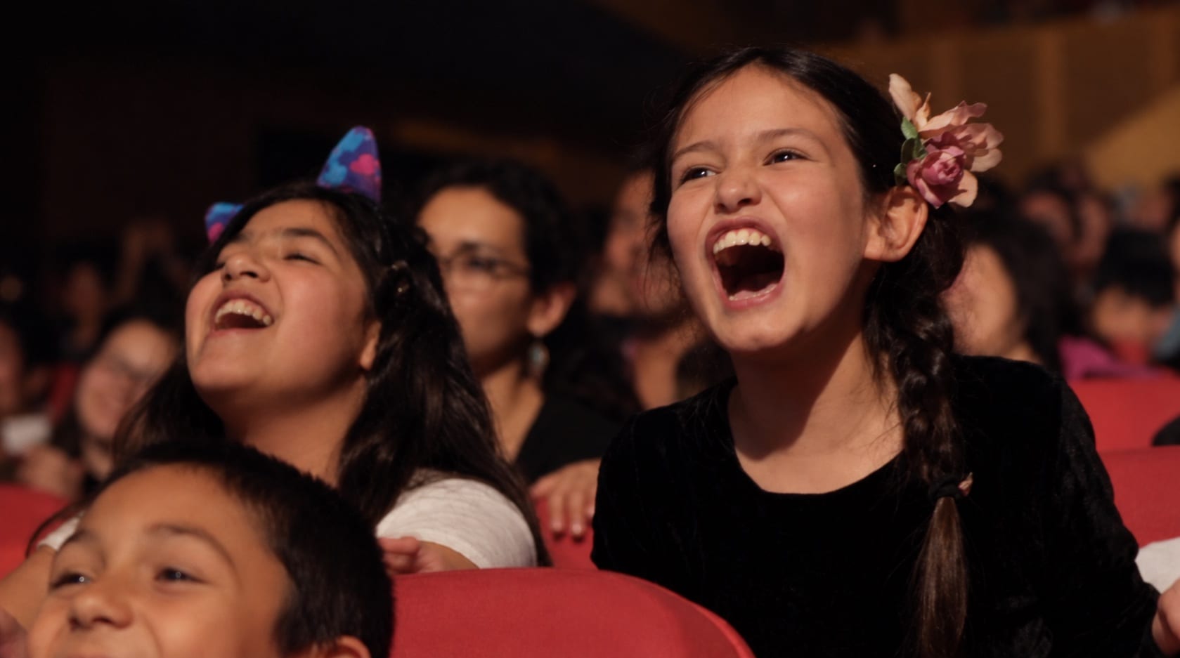 Girls laugh while watching an illusionism experience